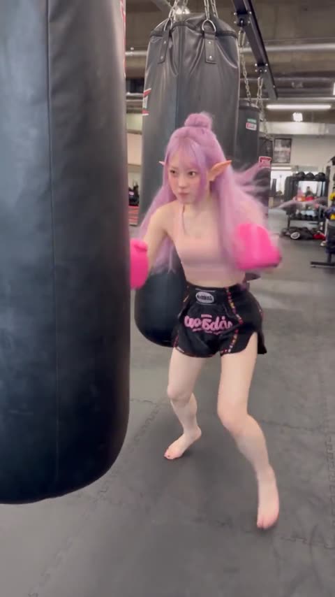 CatSumie practicing Muay Thai on a heavy bag